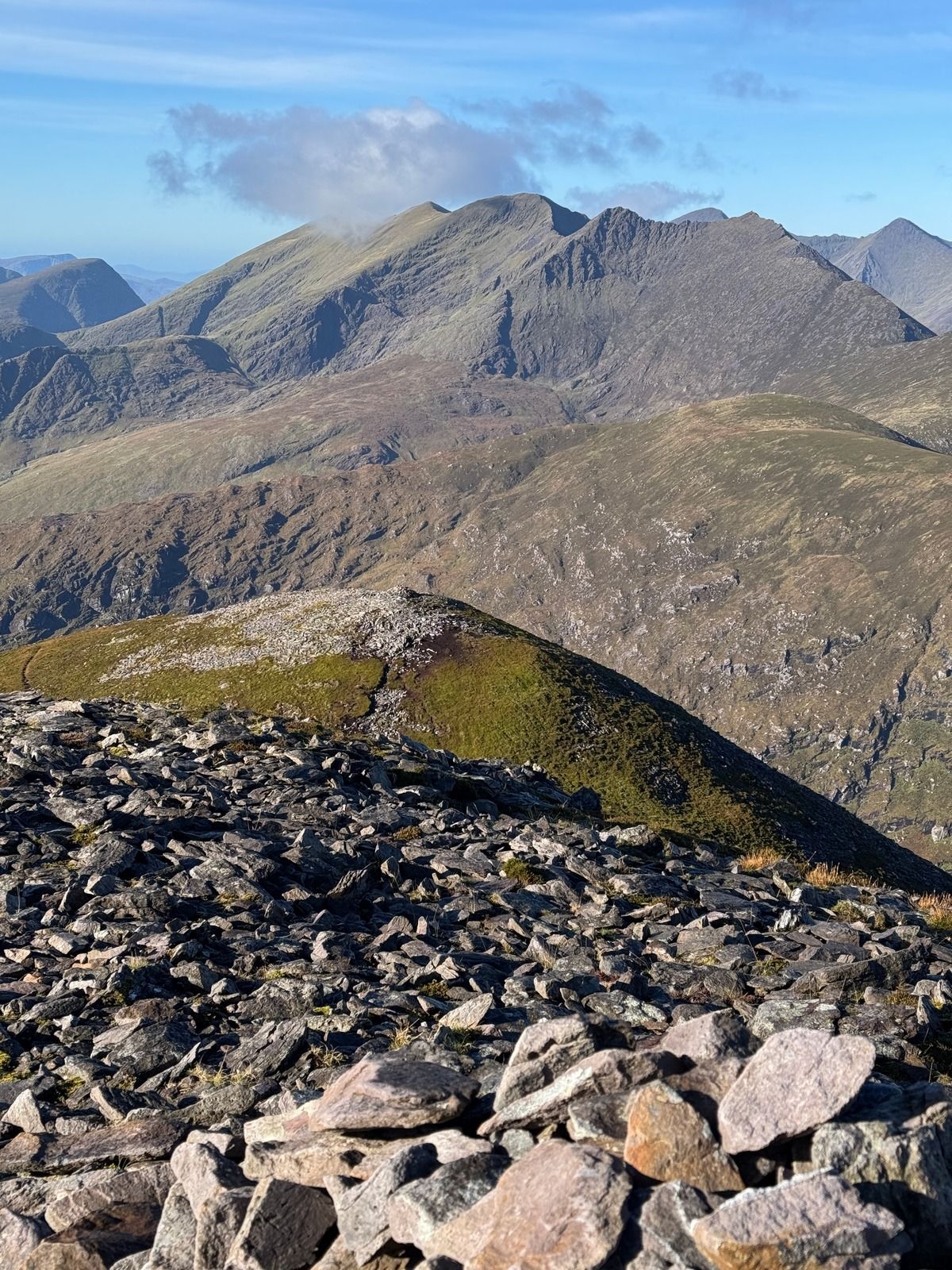 Broken slate in the foreground with the Reeks rising beyond