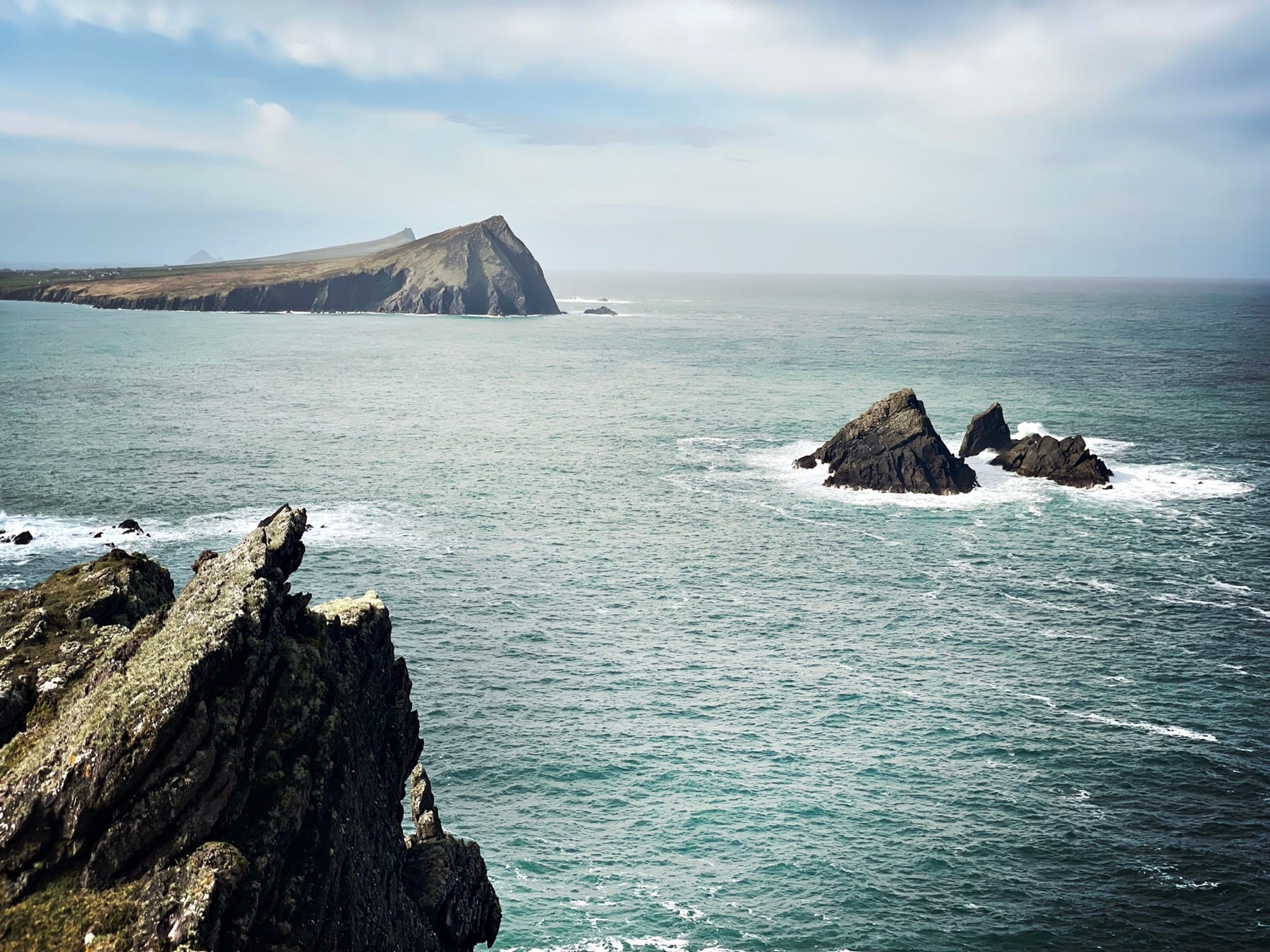 Rocky sea stacks and Sybil Head across the Atlantic