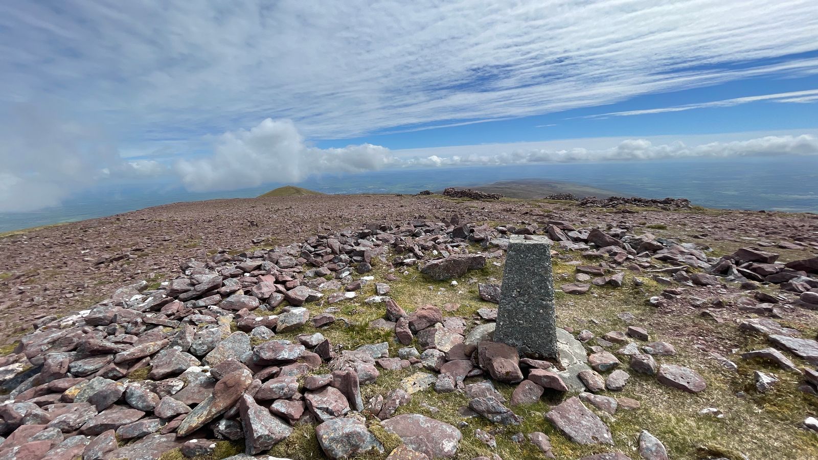 The trig pillar on the broad stony summit of Barr Trí gCom