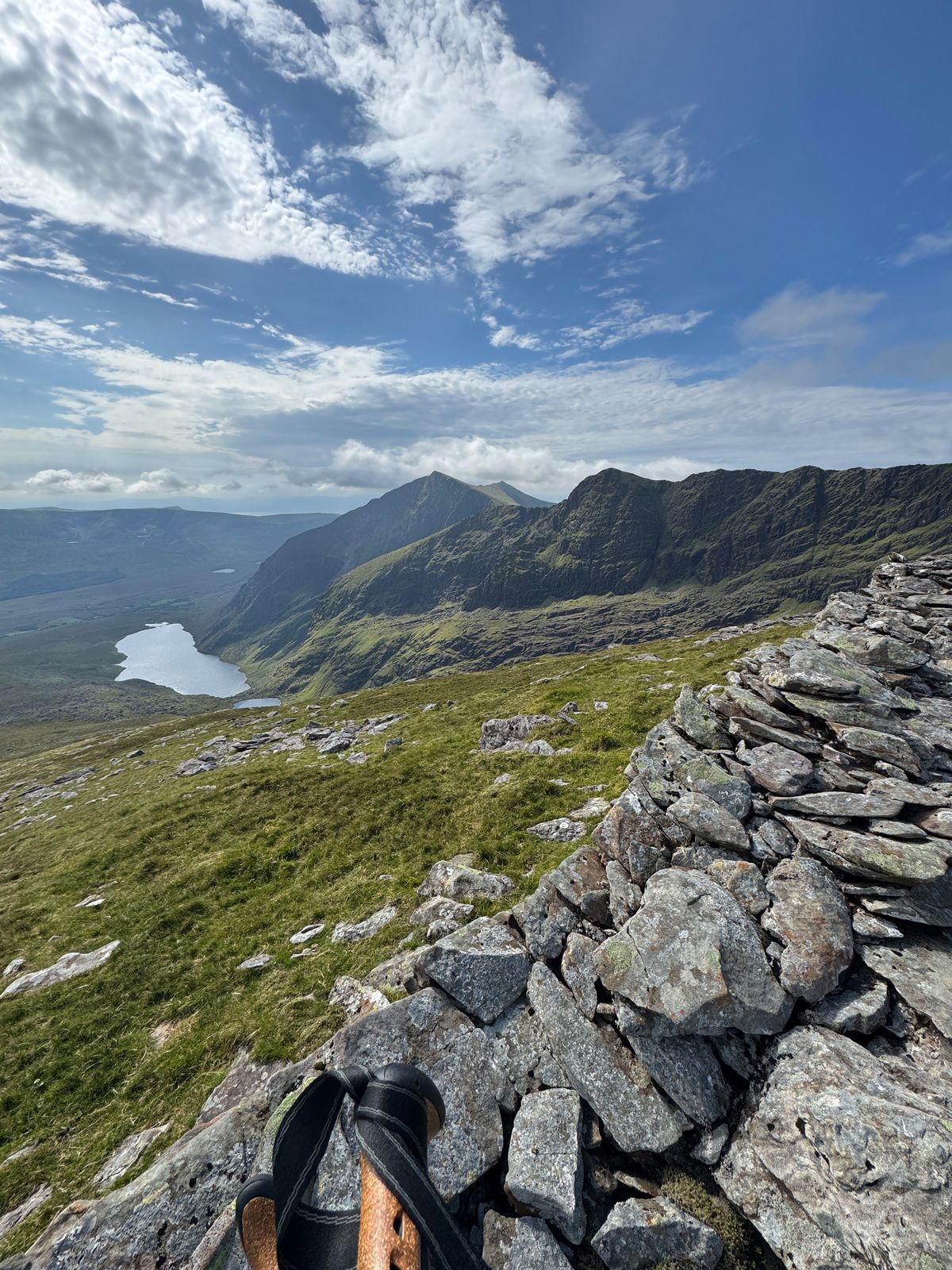 A long corrie and lake seen from rocky high ground