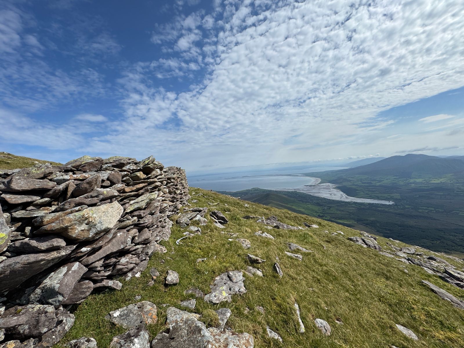A low stone shelter overlooking the coast and mountain country