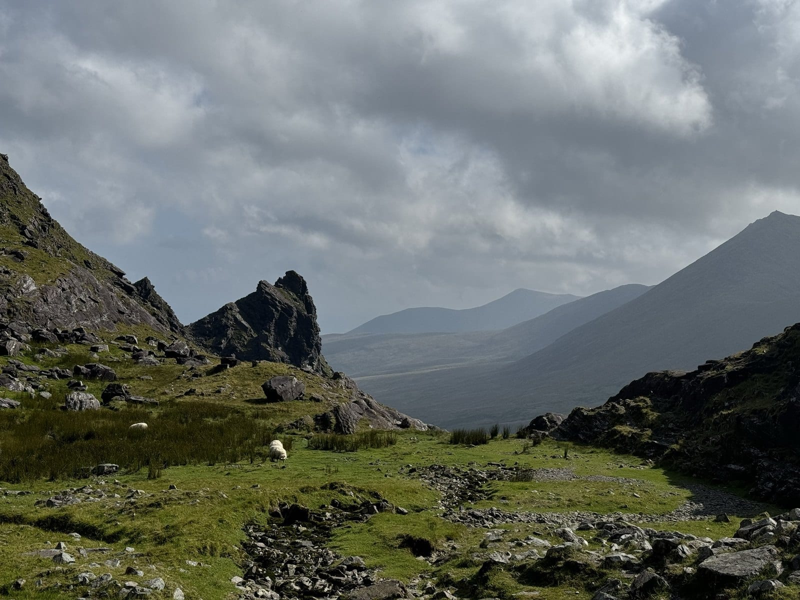 The Hag’s Glen beneath cloud with the MacGillycuddy’s Reeks rising beyond