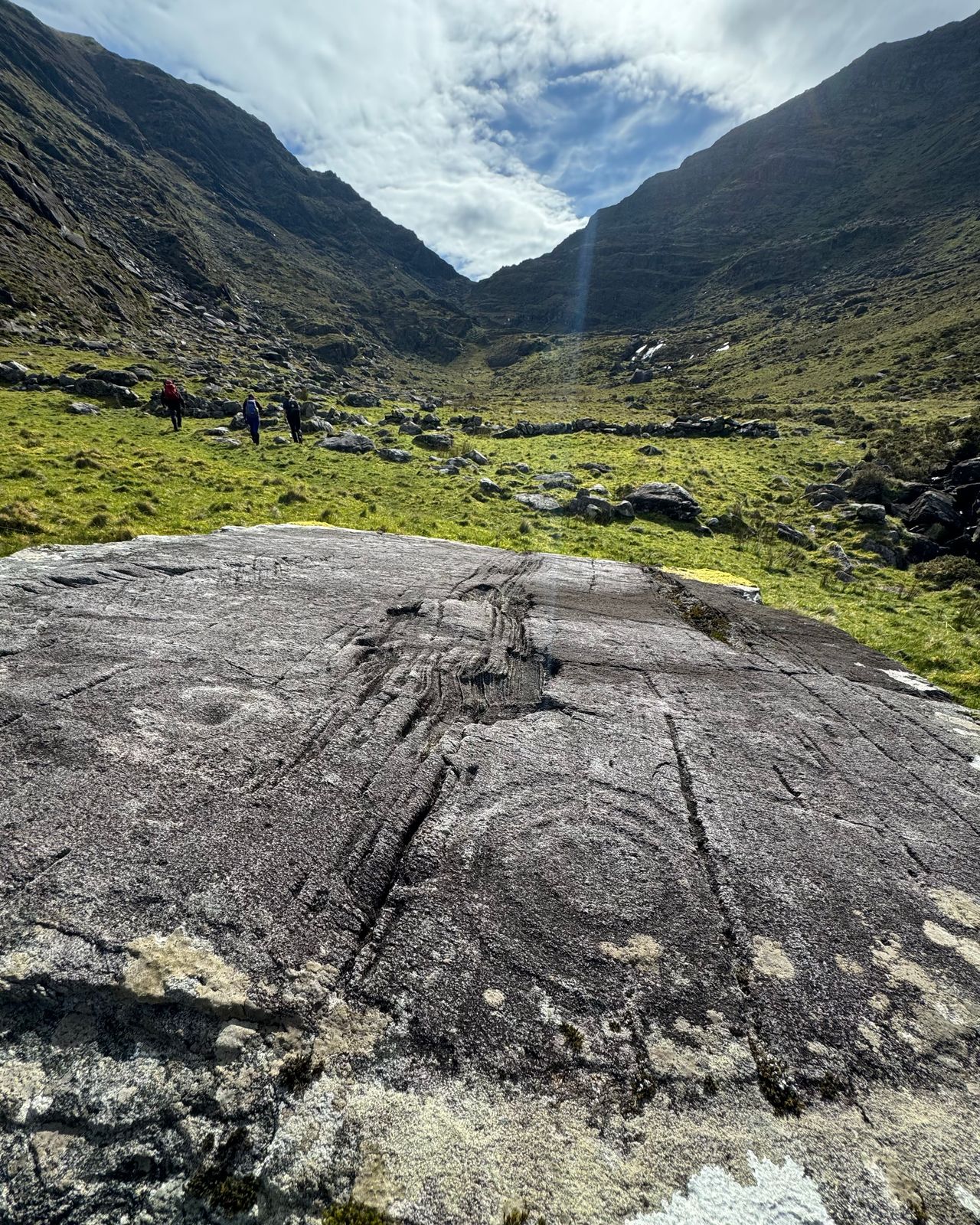 The carved rock at Leaba na Bó with the mountain gully rising behind