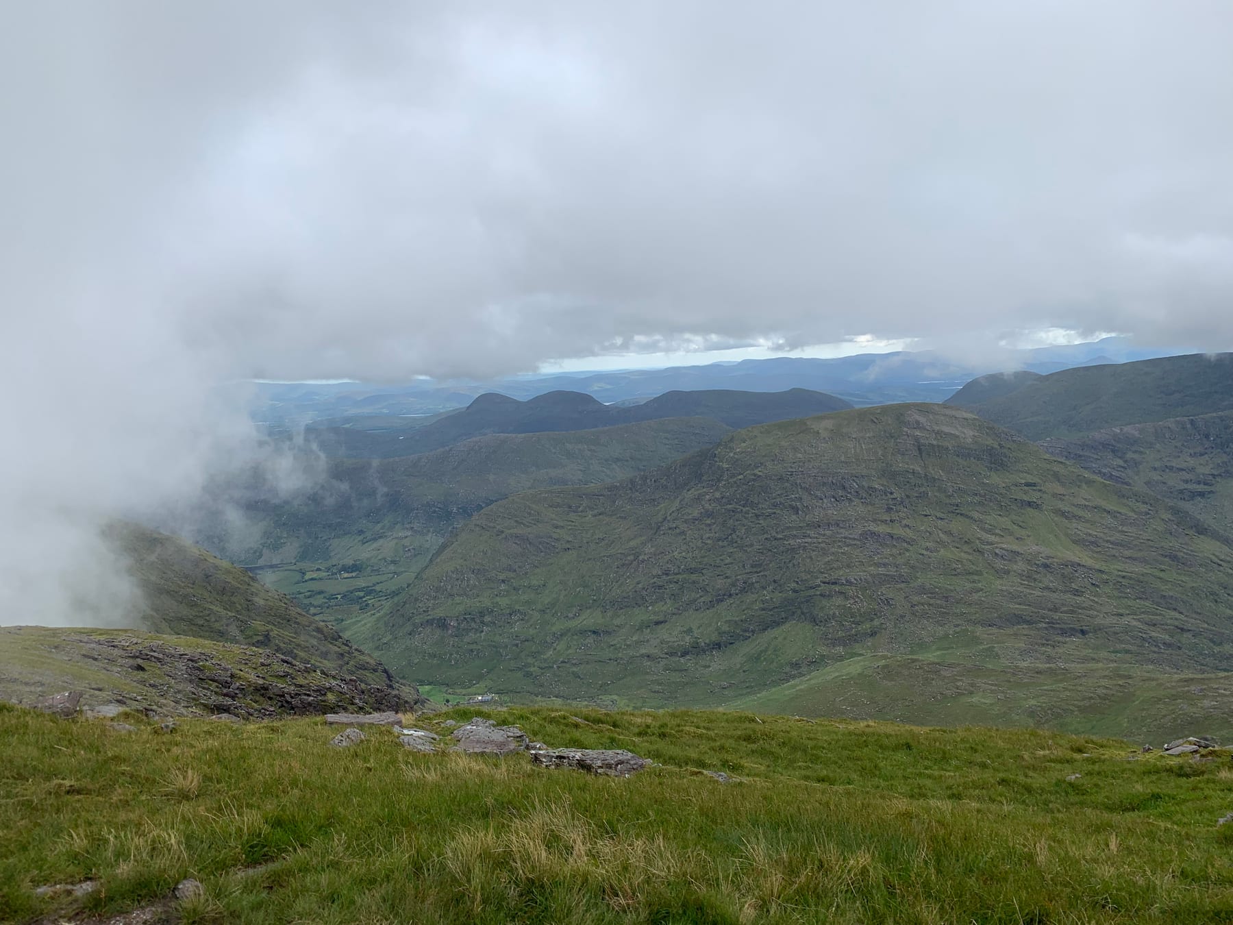 A high view across the green mountains and lakes of the Black Valley