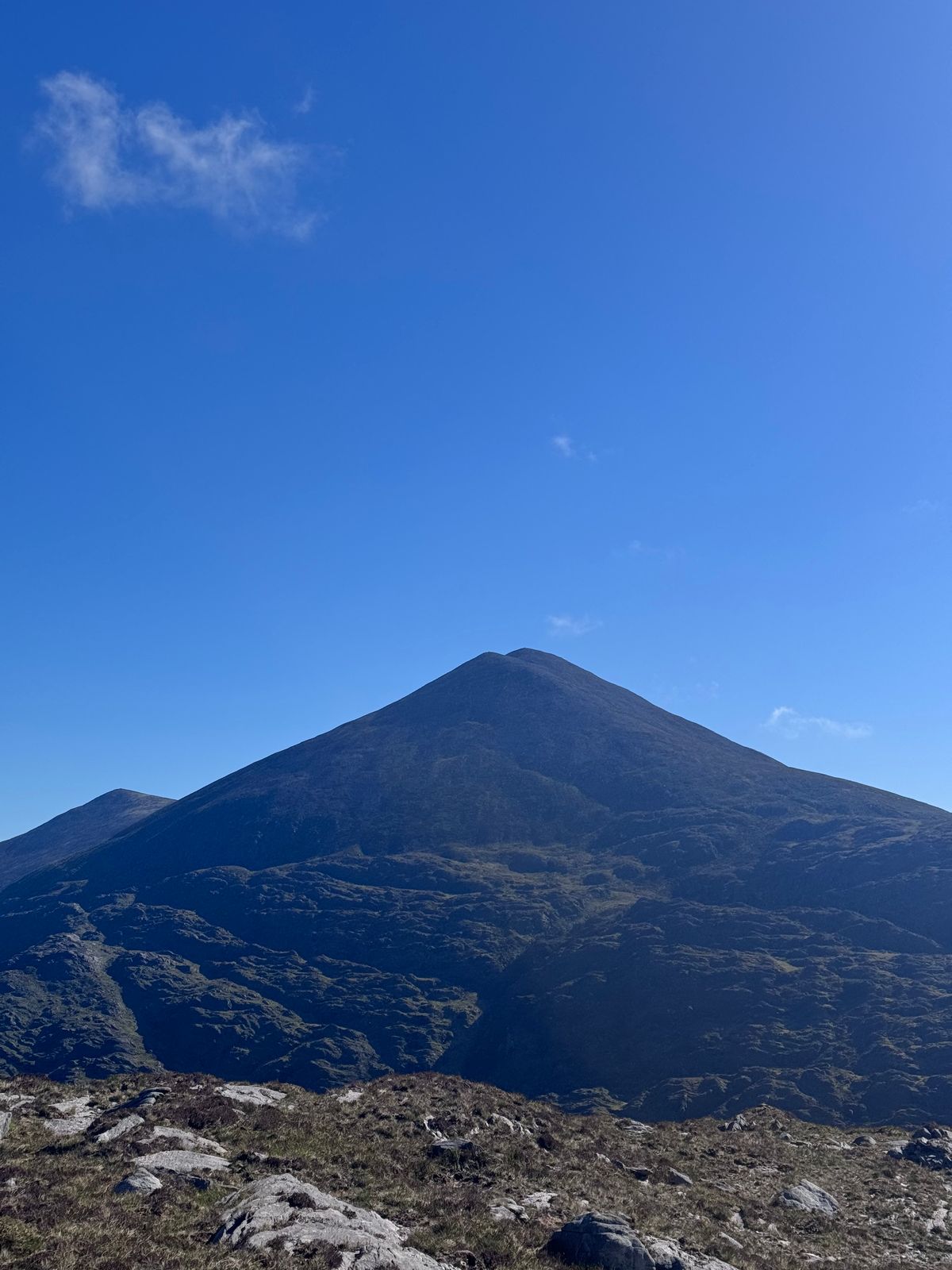 The pointed mountain profile silhouetted beneath a clear blue sky