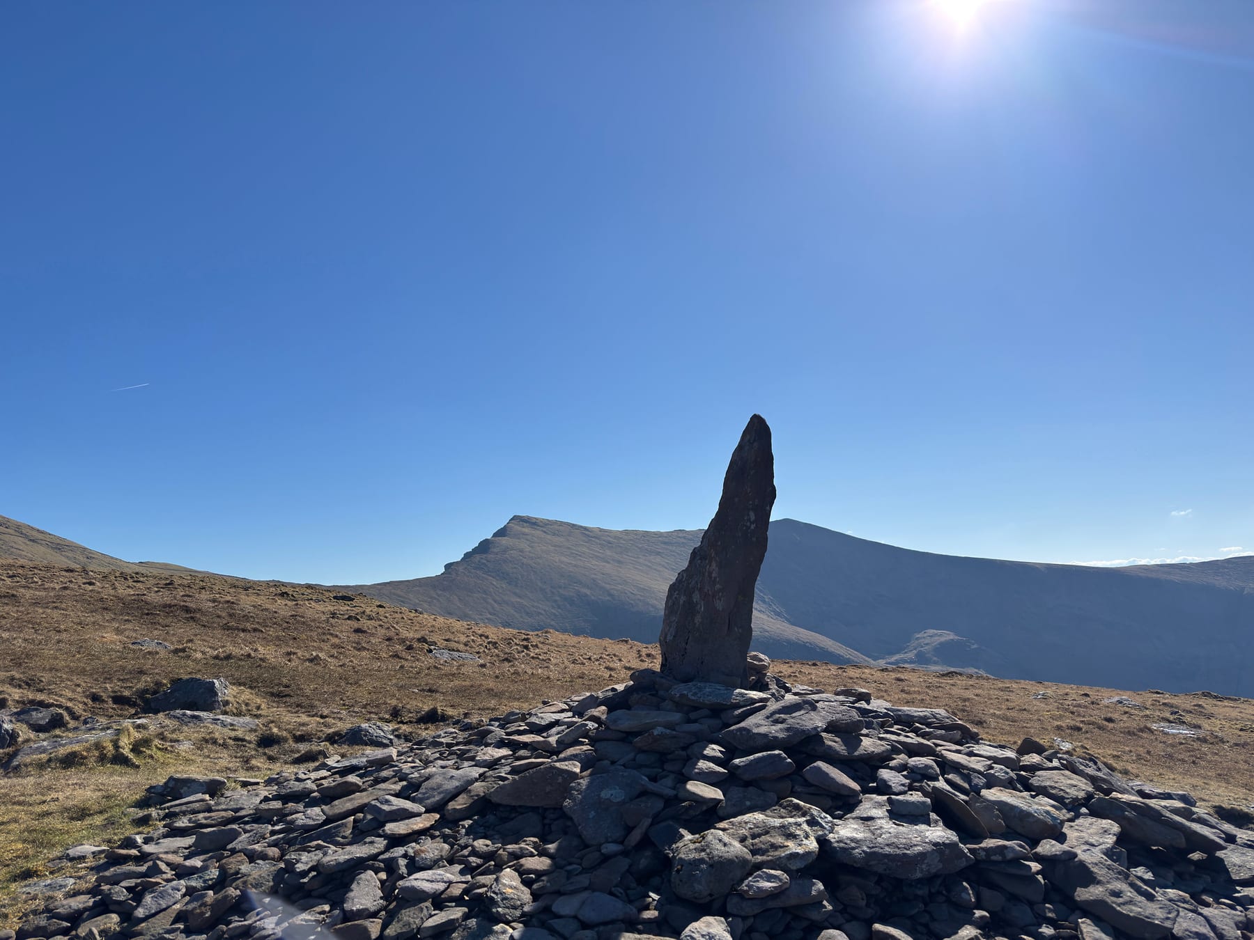Upright stone marker on Mount Brandon with the high ridge behind