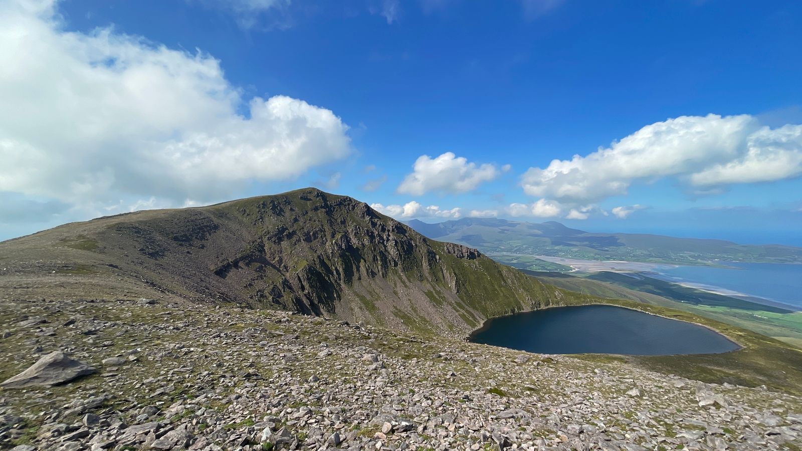A broad stony slope facing the steep ridge above Lough Acummeen