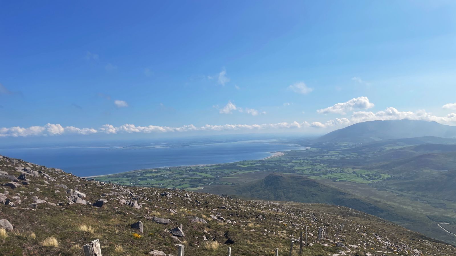 Brandon Bay and coastal fields beyond a rocky mountain shoulder