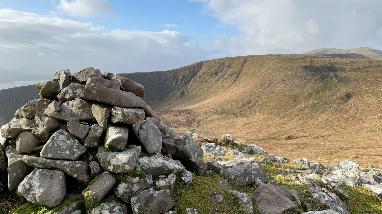 A close stone cairn overlooking the broad brown slopes of Slieve Mish
